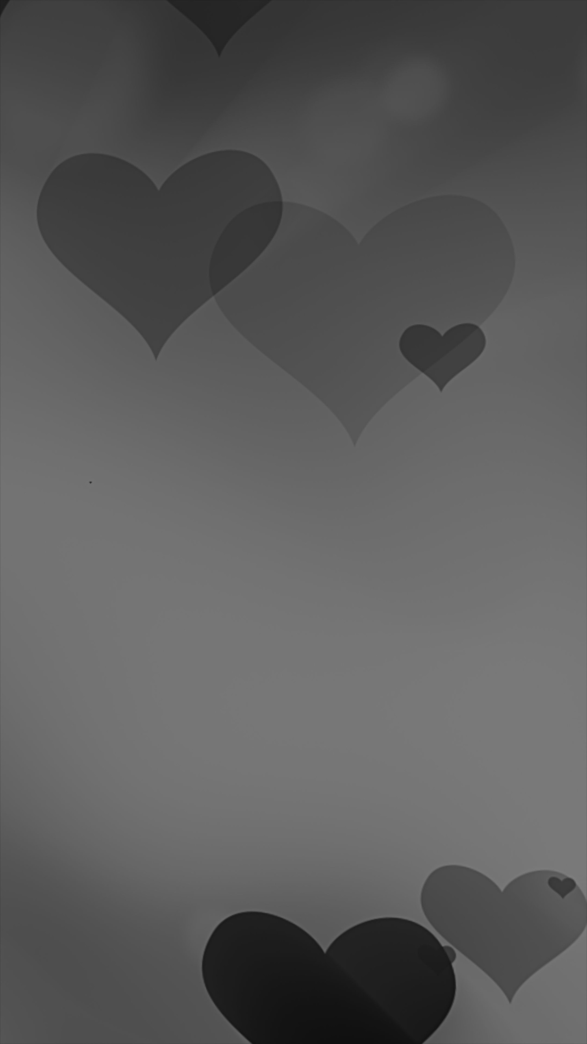 Floating dark hearts in soft monochrome tones on a smooth gradient background